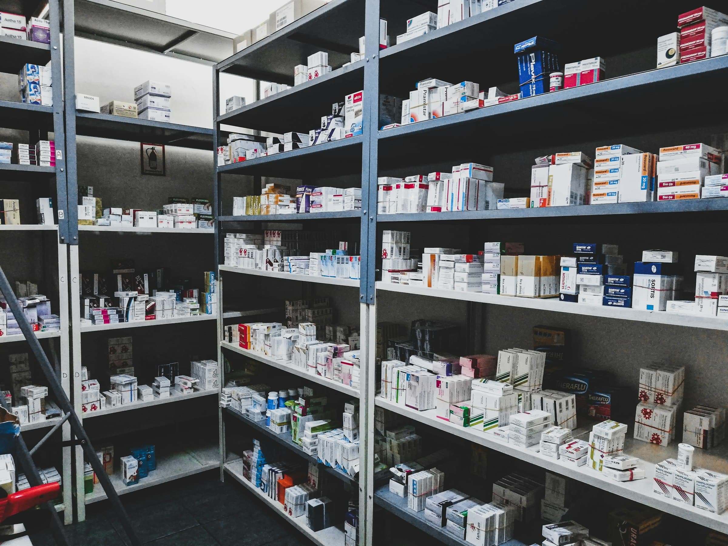 Rows of medication boxes on pharmacy shelves